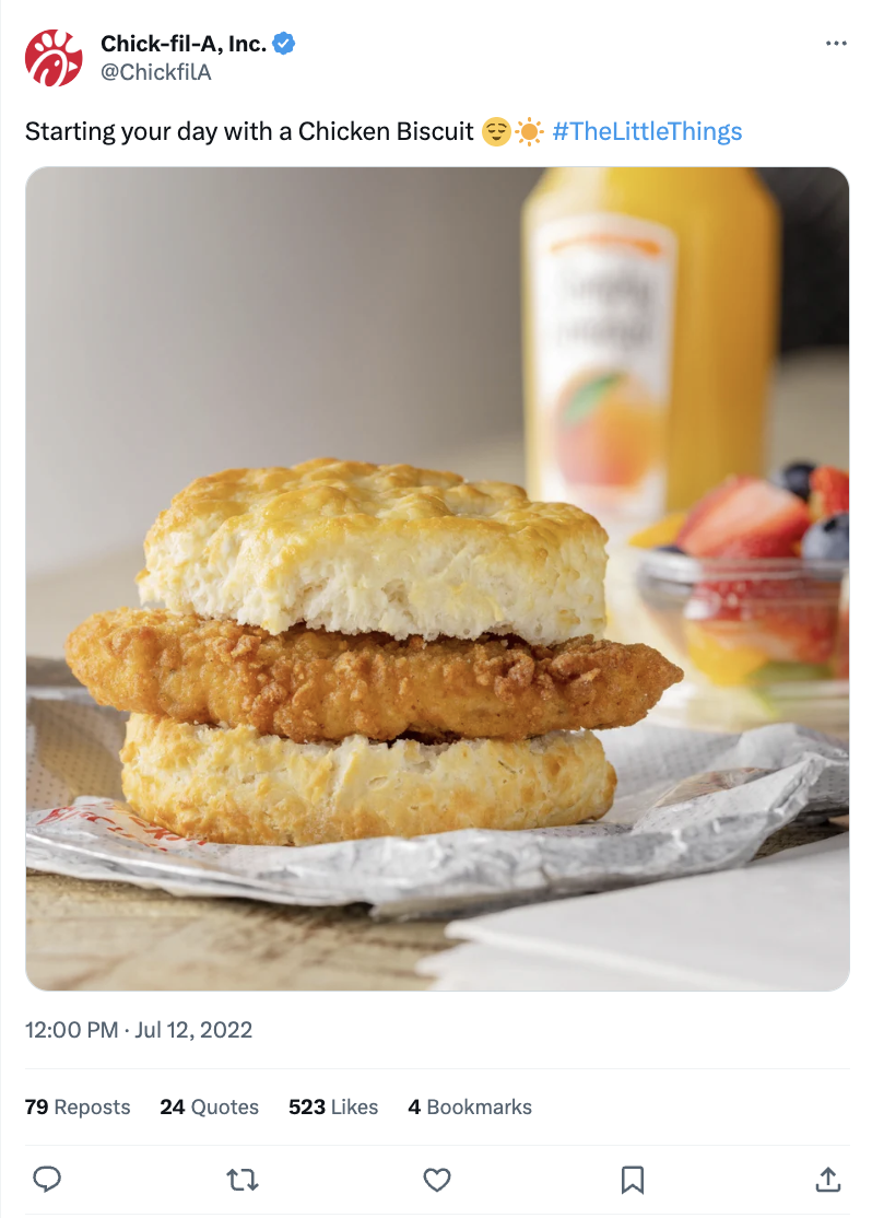 A Chick-fil-A Post on X showing a chicken biscuit, fruit and orange juice. The caption reads, "Starting your day with a chicken biscuit #TheLittleThings."